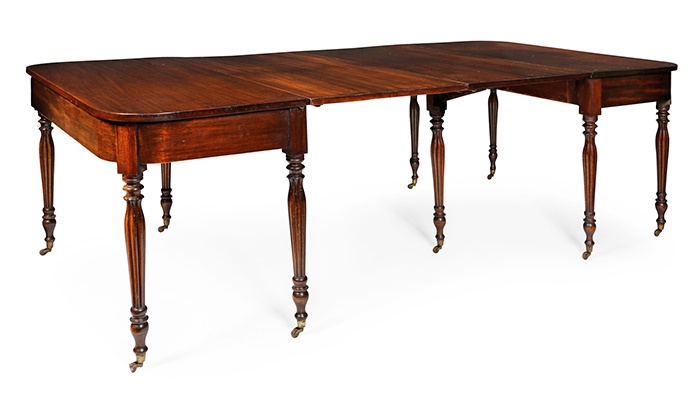 LOT 223 | GILLOWS STYLE MAHOGANY DINING TABLE | 19TH CENTURY with rounded rectangular top, one end with a gateleg, raised on reeded tapered legs and wood castors | 230cm wide, 74cm high, 121cm deep | £600 - £800 + fees